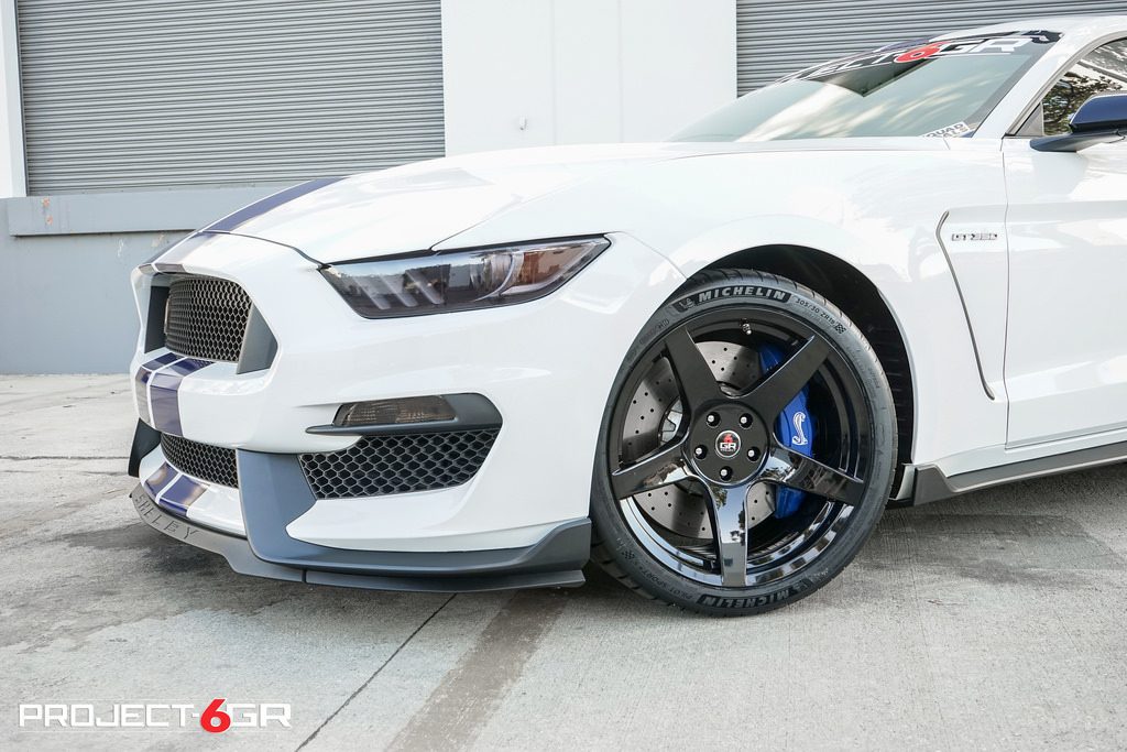 white Mustang with black rims combination