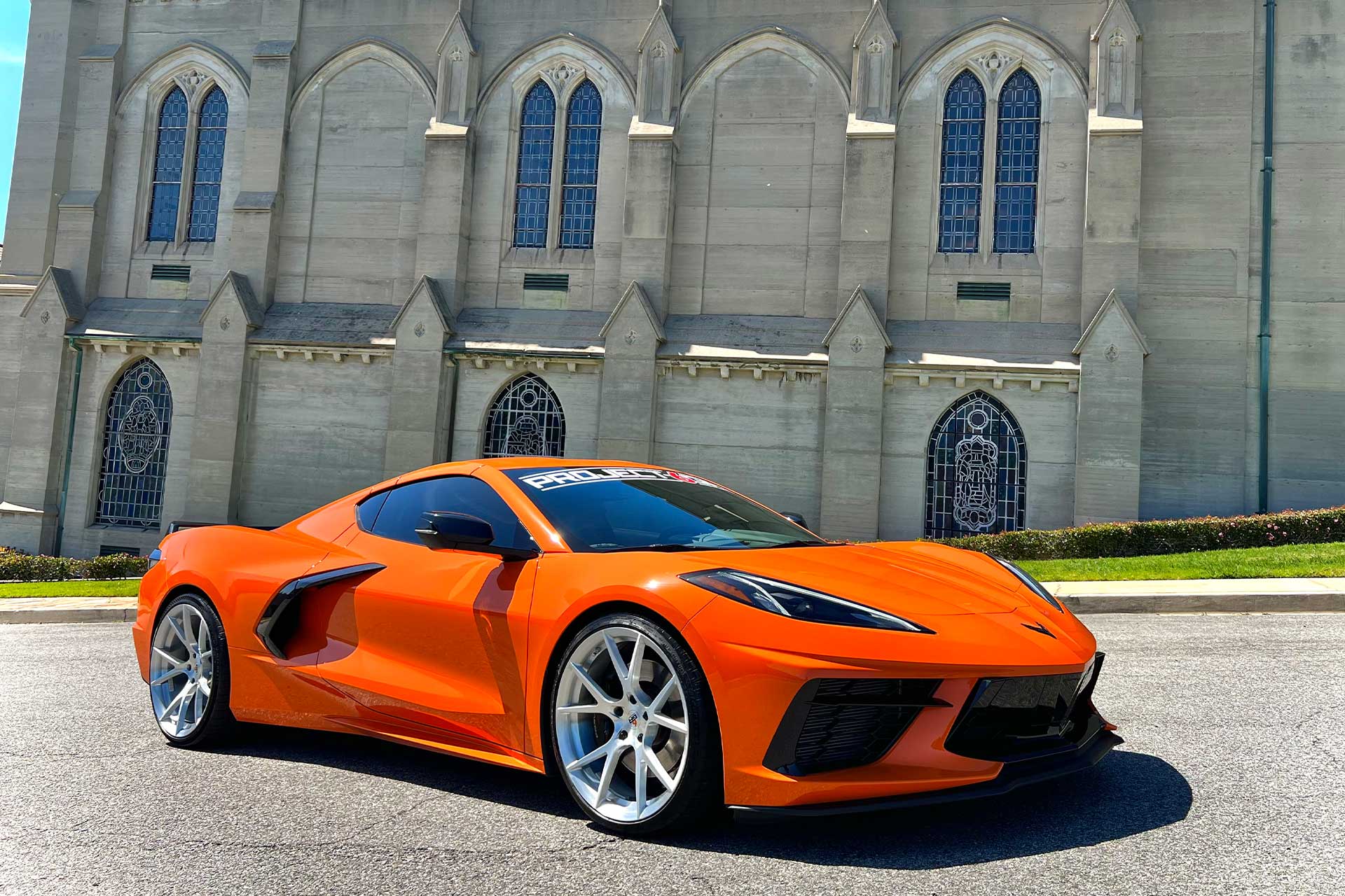 orange c8 chevy corvette with silver project 6gr ten wheels